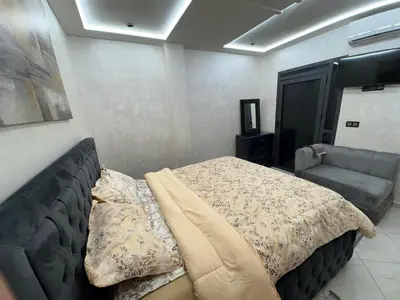 a bedroom with a bed and a couch at Lamoulian stay in Fès