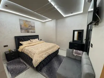 a bedroom with a bed and a couch in it at Lamoulian stay in Fès