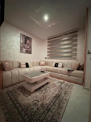a living room with a couch and a coffee table at Lamoulian stay in Fès