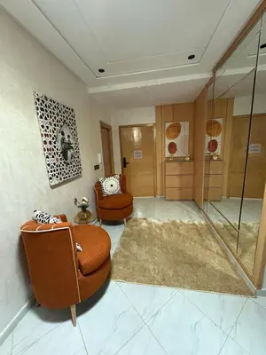 a living room with two chairs and a glass shower at Lamoulian stay in Fès