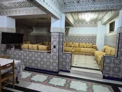 a living room with couches and a flat screen tv at Appartement familial 110 m2 in Meknès