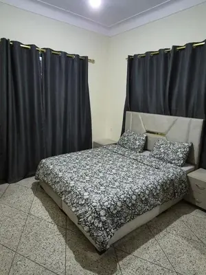 a bedroom with a bed with black curtains at Appartement familial 110 m2 in Meknès