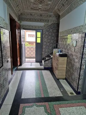a bathroom with a door and a tile floor at Appartement familial 110 m2 in Meknès