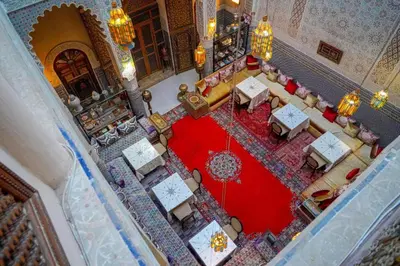an overhead view of a restaurant with tables and chairs at Riad Fez social club in Fès