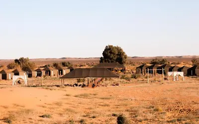 a group of tents in the middle of a field at Desert Paradise Lodging in Merzouga