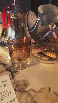 a cup of tea and a plate of food on a table at khamsin home in Oulad Akkou