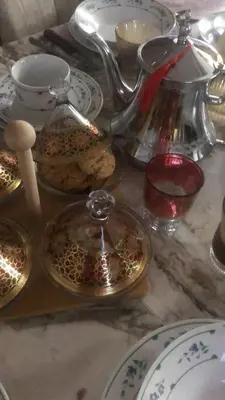 a table topped with plates and a tea pot and dishes at khamsin home in Oulad Akkou