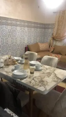 a table with plates on it in a living room at khamsin home in Oulad Akkou
