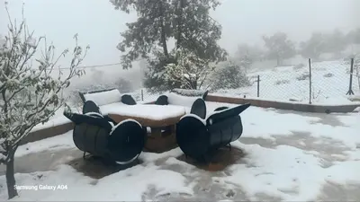 a table covered in snow in a yard at Tigmi Nlkhir in Aït Irizane