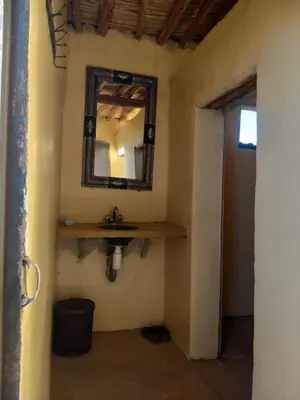 a bathroom with a sink and a mirror on the wall at Camp Nuyum in Ksiba