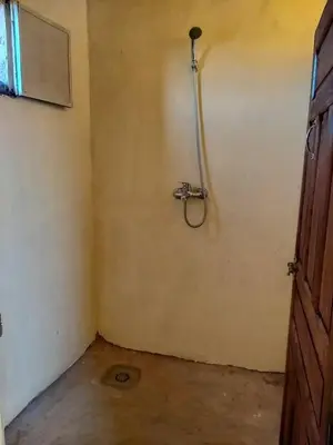 a bathroom with a shower in the corner of a room at Camp Nuyum in Ksiba