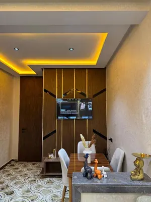 a dining room with a table and a television at Meknes Relax Home in Meknès