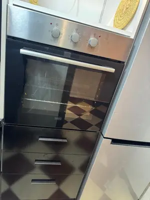an oven with a glass door in a kitchen at Meknes Relax Home in Meknès