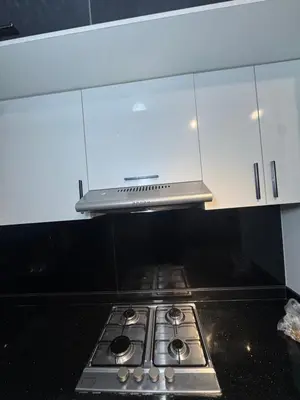 a stove top in a kitchen with white cabinets at Meknes Relax Home in Meknès