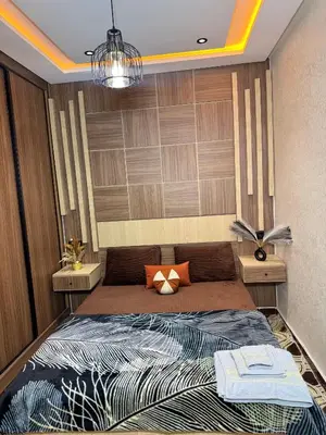 a bedroom with a bed and two night stands at Meknes Relax Home in Meknès
