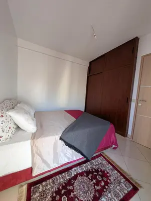 a bedroom with a bed with an umbrella on it at Apartment in Agadir in Oulad Akkou