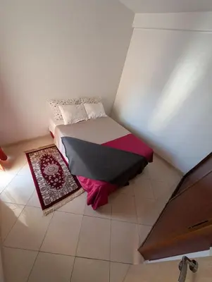 a small bedroom with a bed in a room at Apartment in Agadir in Oulad Akkou