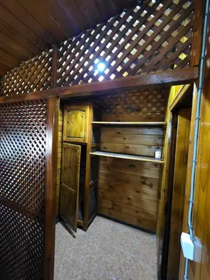 an inside view of a room with wooden walls at Auberge RAMZ'S in Beni Mellal