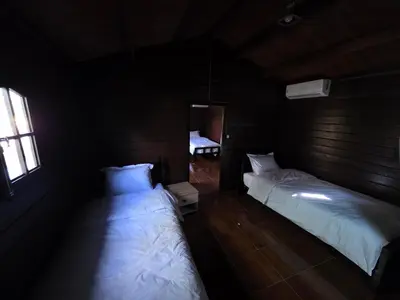 a bedroom with two beds in a room with a window at Auberge RAMZ'S in Beni Mellal