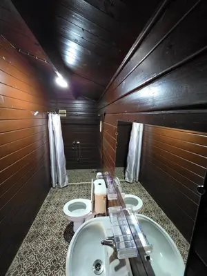 a bathroom with two toilets and a sink at Auberge RAMZ'S in Beni Mellal
