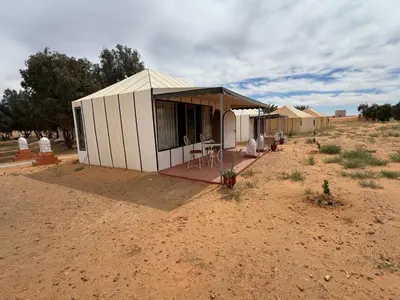 a small house in the middle of the desert at Merzouga Desert Camping in Hassilabied