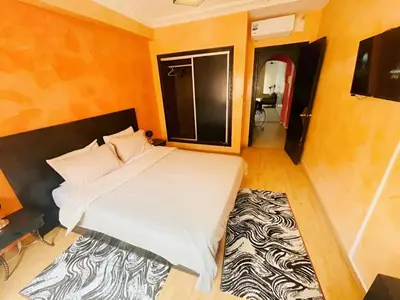 a bedroom with a bed and a zebra rug at Comfortable Apartment with Pool in Oulad Akkou