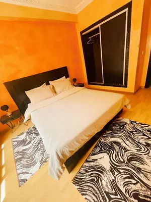 a bed in a room with a large window at Comfortable Apartment with Pool in Oulad Akkou