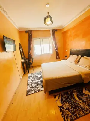 a bedroom with a large bed and a window at Comfortable Apartment with Pool in Oulad Akkou