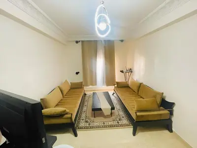 a living room with two couches and a tv at Comfortable Apartment with Pool in Oulad Akkou