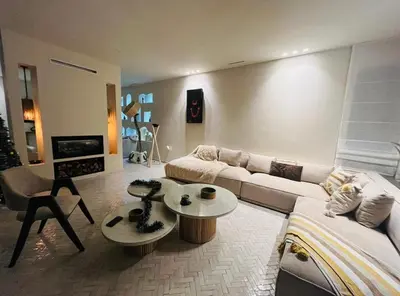 a living room with a couch and a table at villa Bohème Chic in Had Abdallah Rhiat