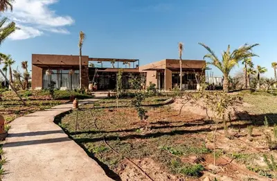 a house on a hill with a path in front of it at villa Bohème Chic in Had Abdallah Rhiat