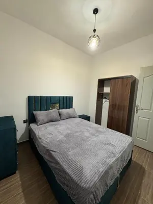 a bedroom with a large bed in a room at Appartement équipé