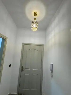 a room with a door and a chandelier at Appartement équipé