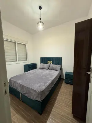 a bedroom with a bed and two night stands at Appartement équipé