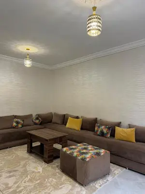 a living room with a couch and a coffee table at Appartement équipé