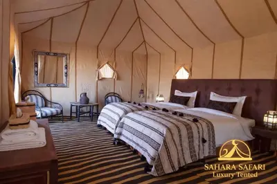 a bedroom with a large bed in a tent at Sahara Safari Luxury Tented in Merzouga