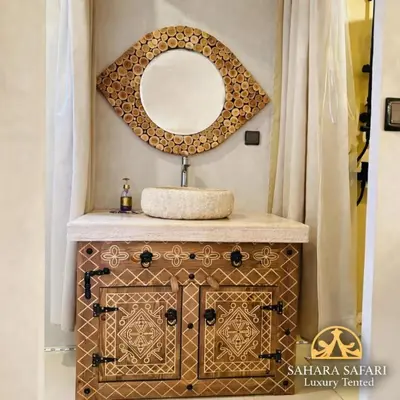 a bathroom with a sink and a mirror at Sahara Safari Luxury Tented in Merzouga