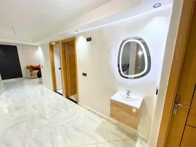 a bathroom with a sink and a mirror at Cures & détente Appartement moderne Université EUROMED in Fès