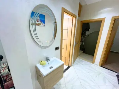 a bathroom with a sink and a mirror on the wall at Premium comfort Appartemment lumineux proche médina in Fès