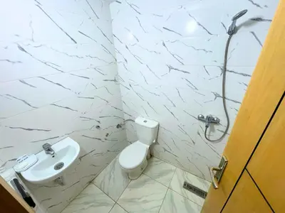 a bathroom with a toilet and a sink at Premium comfort Appartemment lumineux proche médina in Fès