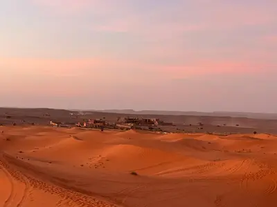 a desert view of a village in the desert at Berber Dreams Desert Camp in Merzouga