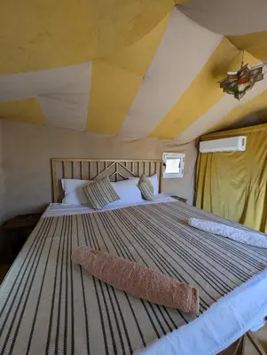 a bedroom with a large bed in a tent at Berber Dreams Desert Camp in Merzouga