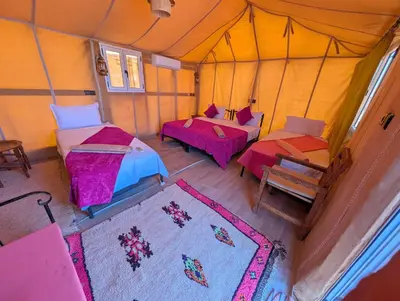 an overhead view of a tent with two beds and tables at Berber Dreams Desert Camp in Merzouga