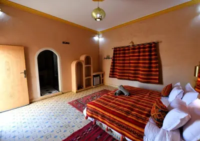 a bedroom with a bed and a window at Riad Ali El Cojo in Hassilabied
