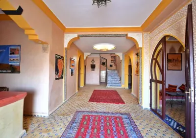 an empty hallway with a rug on the floor at Riad Ali El Cojo in Hassilabied