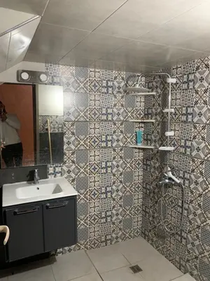 a bathroom with a sink and a shower and a mirror at Nice apartment in Fès