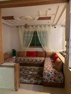 a living room with a couch and a window at Nice apartment in Fès