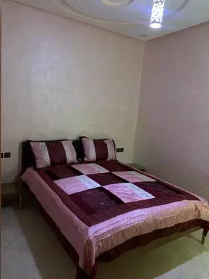 a bedroom with a bed in the corner of a room at Nice apartment in Fès