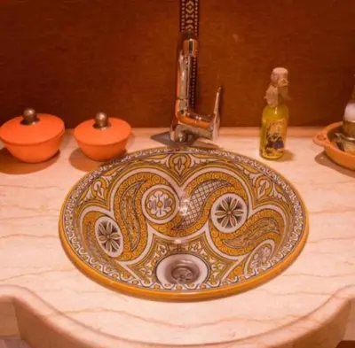 a bathroom sink with an ornate pattern on it at Merzouga Luxury Tented in Merzouga