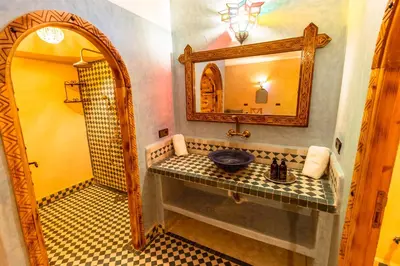 a bathroom with a sink and a mirror at Hotel Sunset palace Merzouga in Merzouga